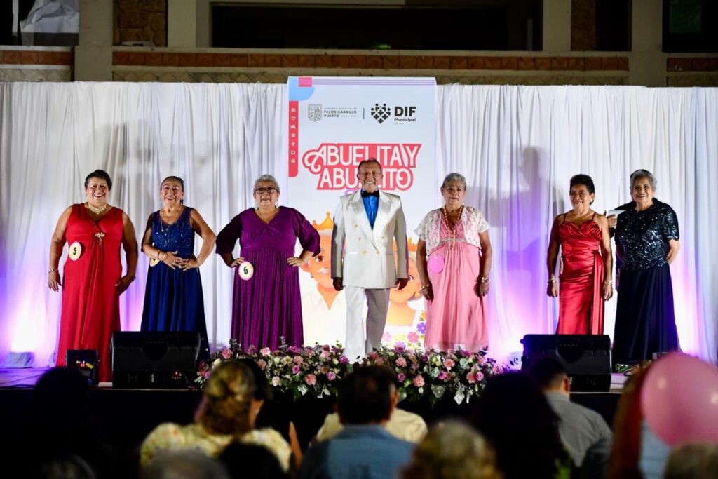 Participantes del certamen desfilan sobre el escenario durante la coronación y celebración dedicada a los adultos mayores.